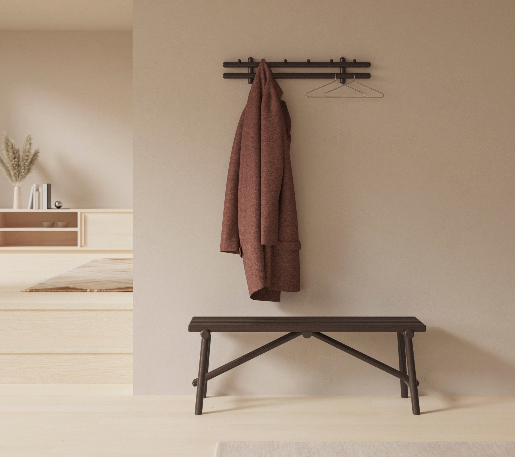 Un entorno minimalistico con un banco de madera y un abrigo colgado en un estante montado en la pared, realzando la simplicidad y la funcionalidad del espacio.