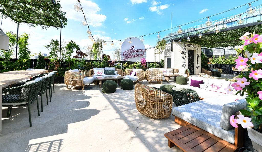 Grace Garden. bar and lounge, green outdoor dining chairs, round lounge chairs, lounge chairs in natural, green plants, blooming flowers 