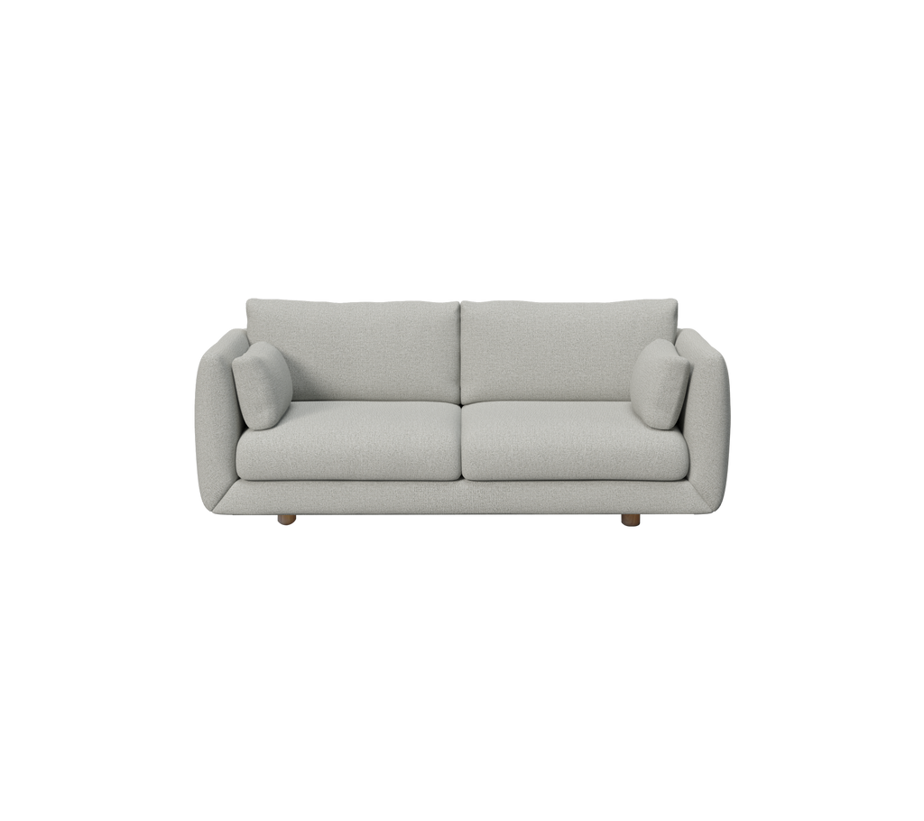 Sofá moderno gris claro con cojines redondeados en un diseño minimalista.