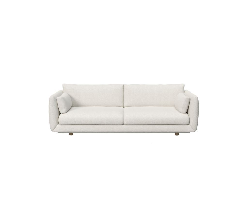 Sofá blanco moderno con cojines cilíndricos.