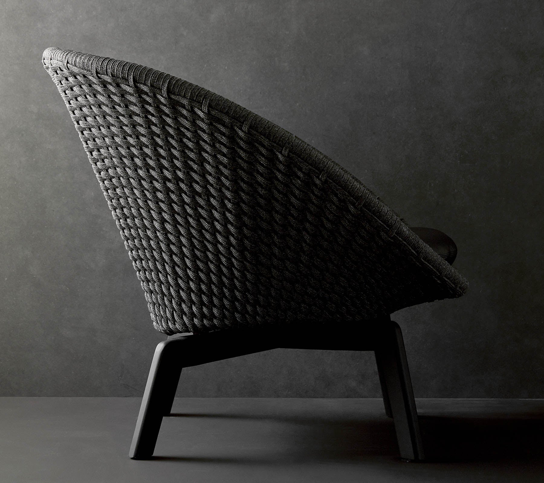 Silla tejida elegante con una silueta esbelta y patas resistentes, perfecta para una decoración moderna.