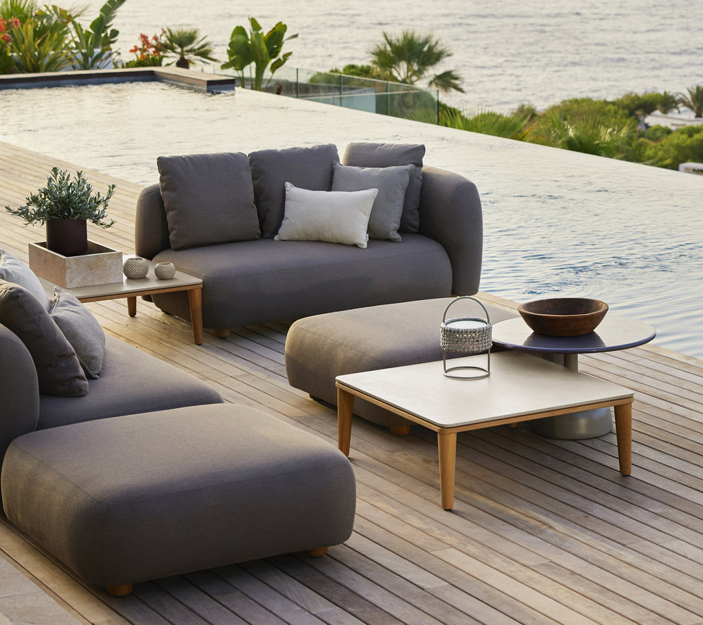 Muebles de sala al aire libre modernos con sofá gris, silla y mesa de café de madera.
