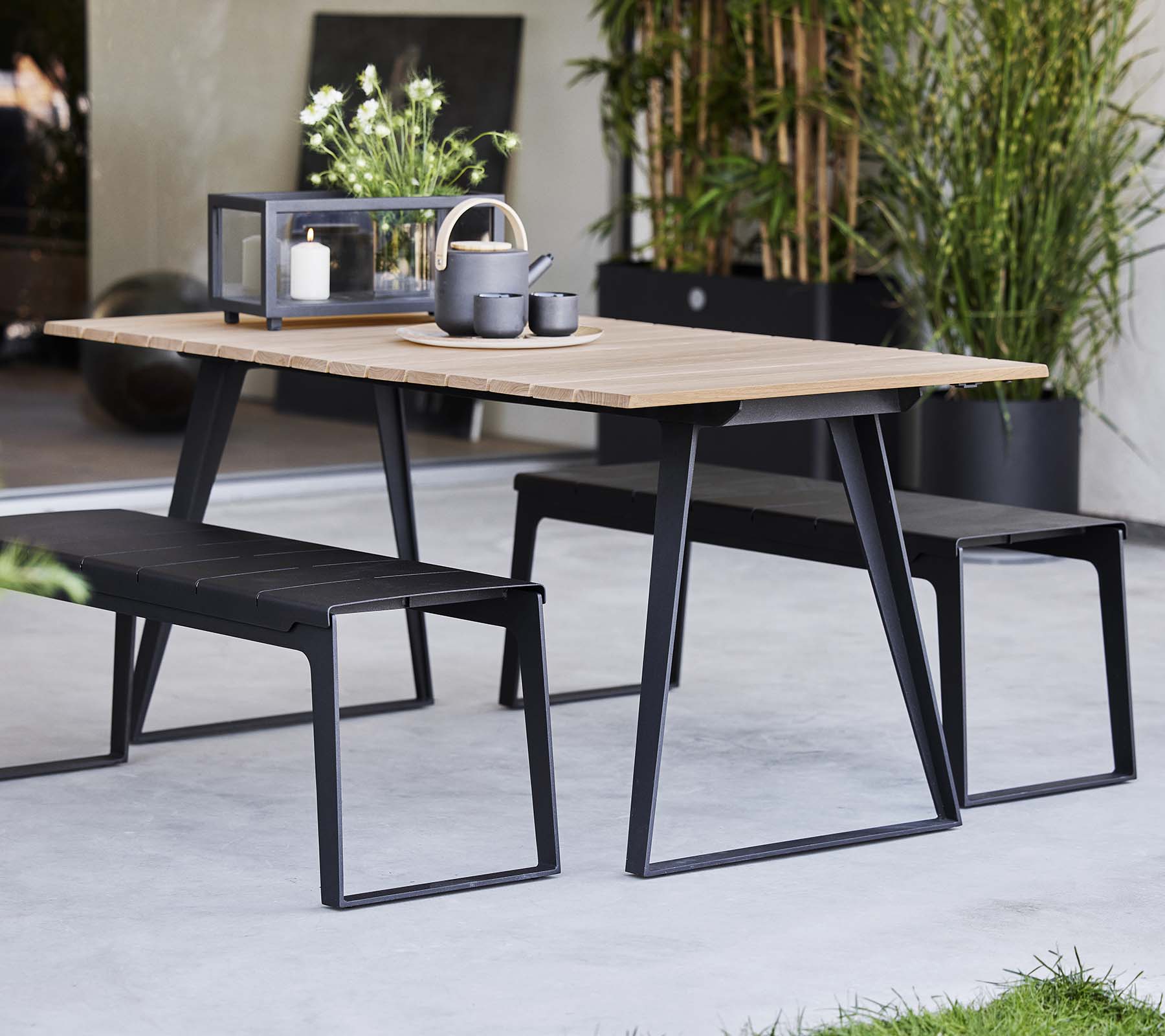 Mesa elegante de Copenhague acompañada de bancos a juego, con un diseño moderno y elementos de decoración minimalistas.